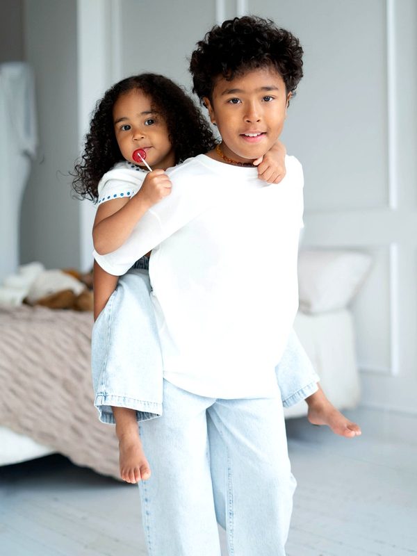Big brother carrying his little sister on his back
